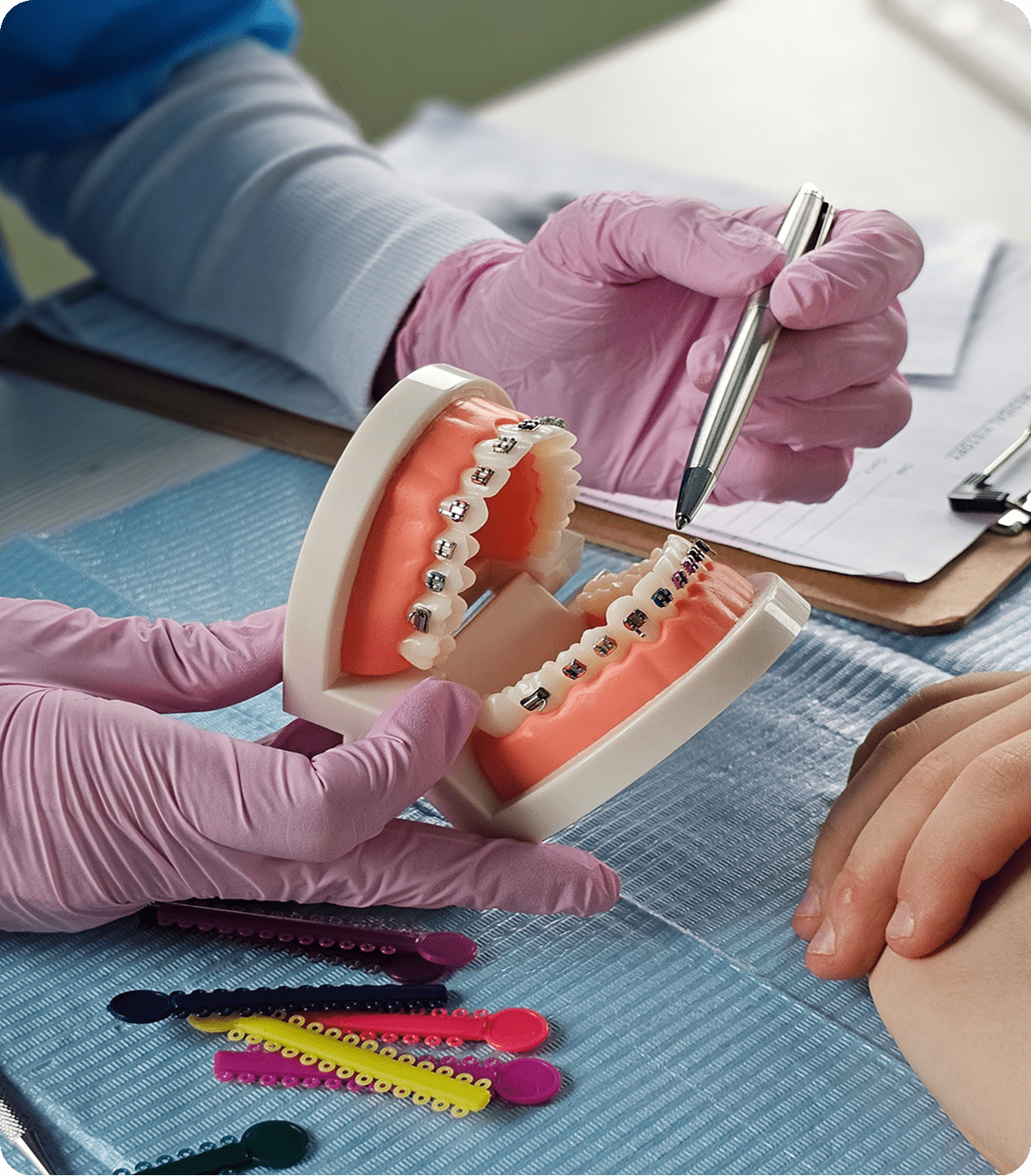 Dentist explaining braces with model